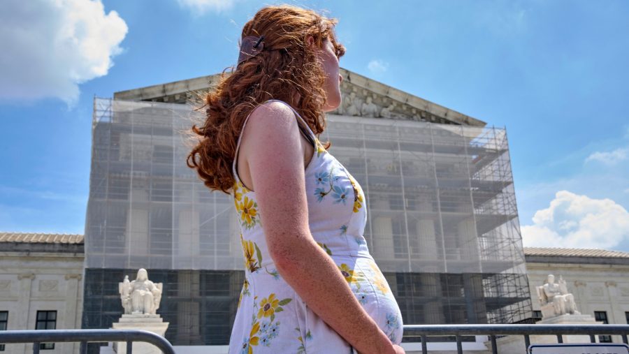 FILE - Mairelise Robinson, a U.S. citizen who is 6 months pregnant, attends a protest in support of birthright citizenship, outside of the Supreme Court in Washington, May 15, 2025.