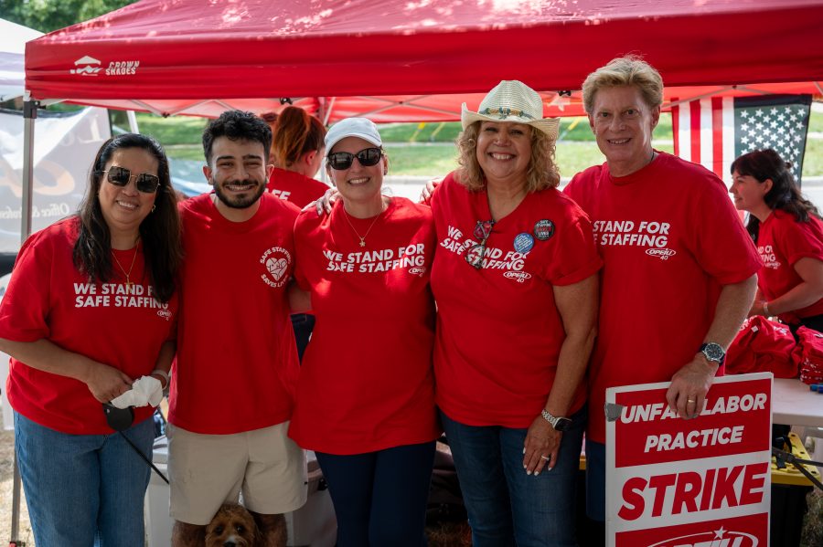 Health care workers strike outside of McLaren Macomb Hospital on July 8, 2025, over staffing and pay dissatisfaction.