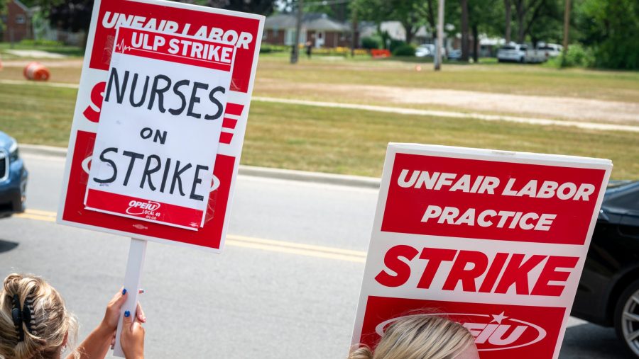 Health care workers strike outside of McLaren Macomb Hospital on July 8, 2025, over staffing and pay dissatisfaction.