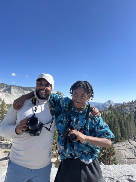 Photographer Robel Fessehatzion poses with a student at Yosemite