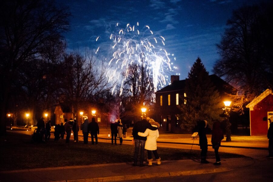 People in winter coats admire fireworks at The Henry Ford
