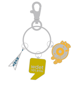 Key chain with charms featuring an antenna, a reeocord with music notes and the WDET logo.