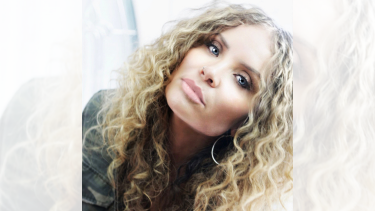 Headshot of Jennifer Washington Hill, she has curly blonde hair.