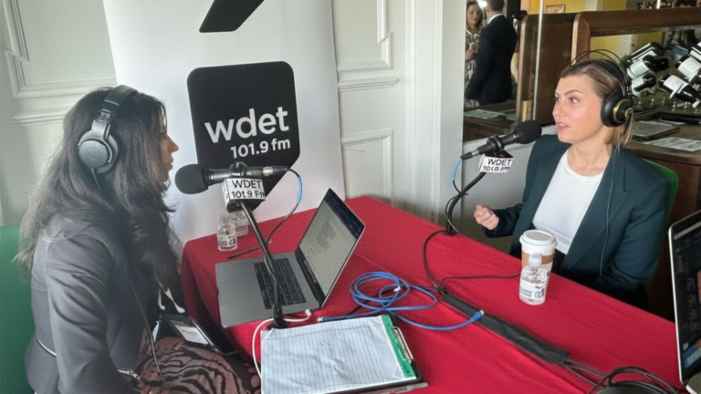 Senator Slotkin sits with The Metro's Robyn Vincent at a table with microphones
