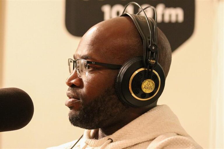 Side profile of Cecil Jones with headphones on, in front of a mic.