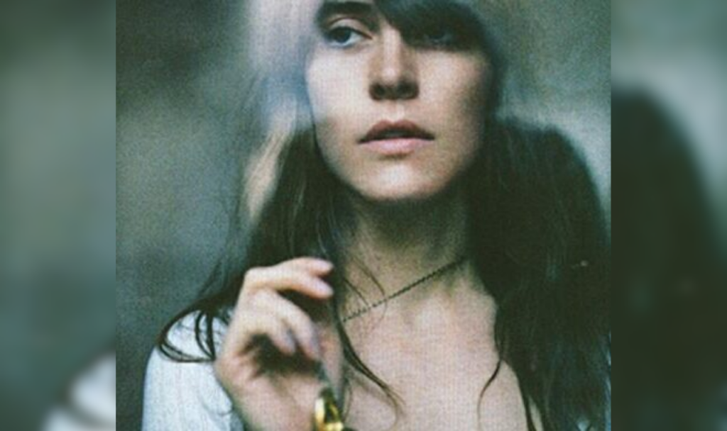 A blurred closeup of a woman with brown hair.