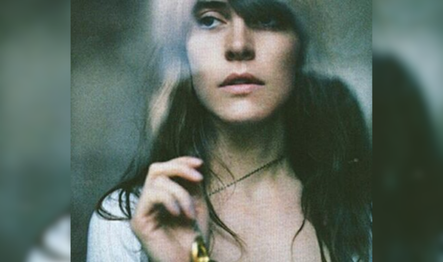 A blurred closeup of a woman with brown hair.