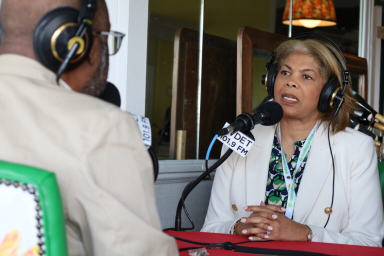 Portia Roberson faces Jerome Vaughn as she speaks into the mic.