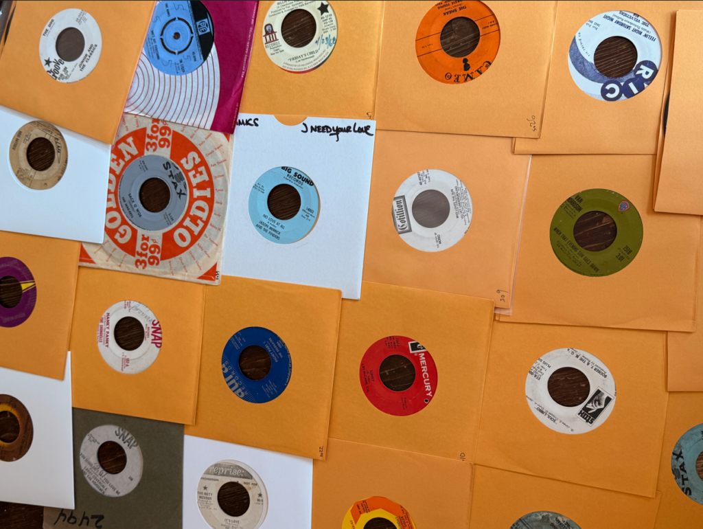 A grid of vinyl records, mostly in yellow sleeves with just the label showing.
