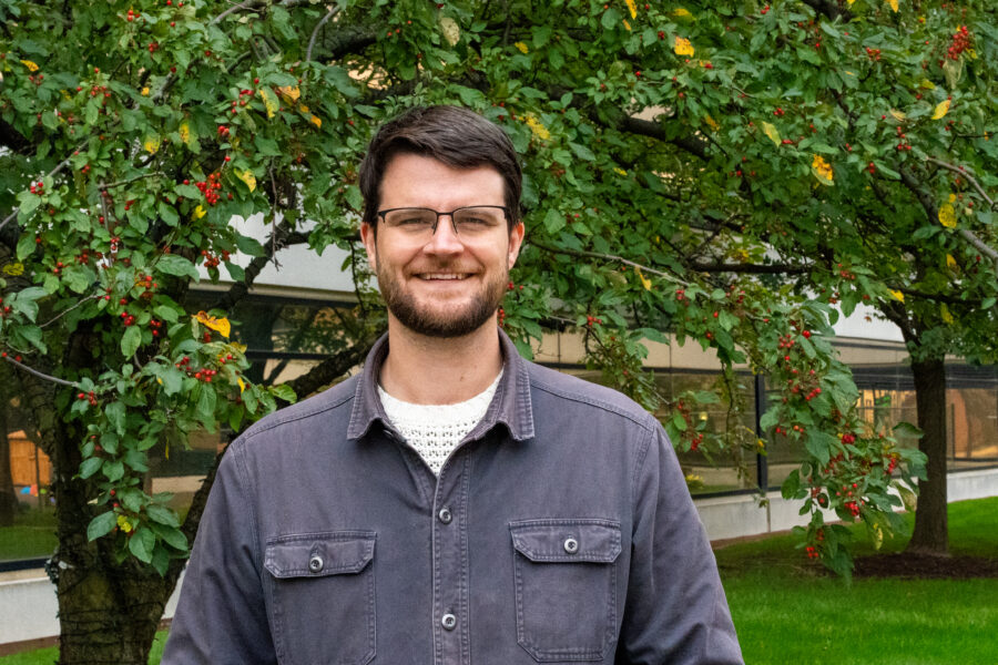 William Lawrence stands in front of a tree.