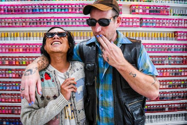 The Twisted Teens in front of a colorful nail polish display.